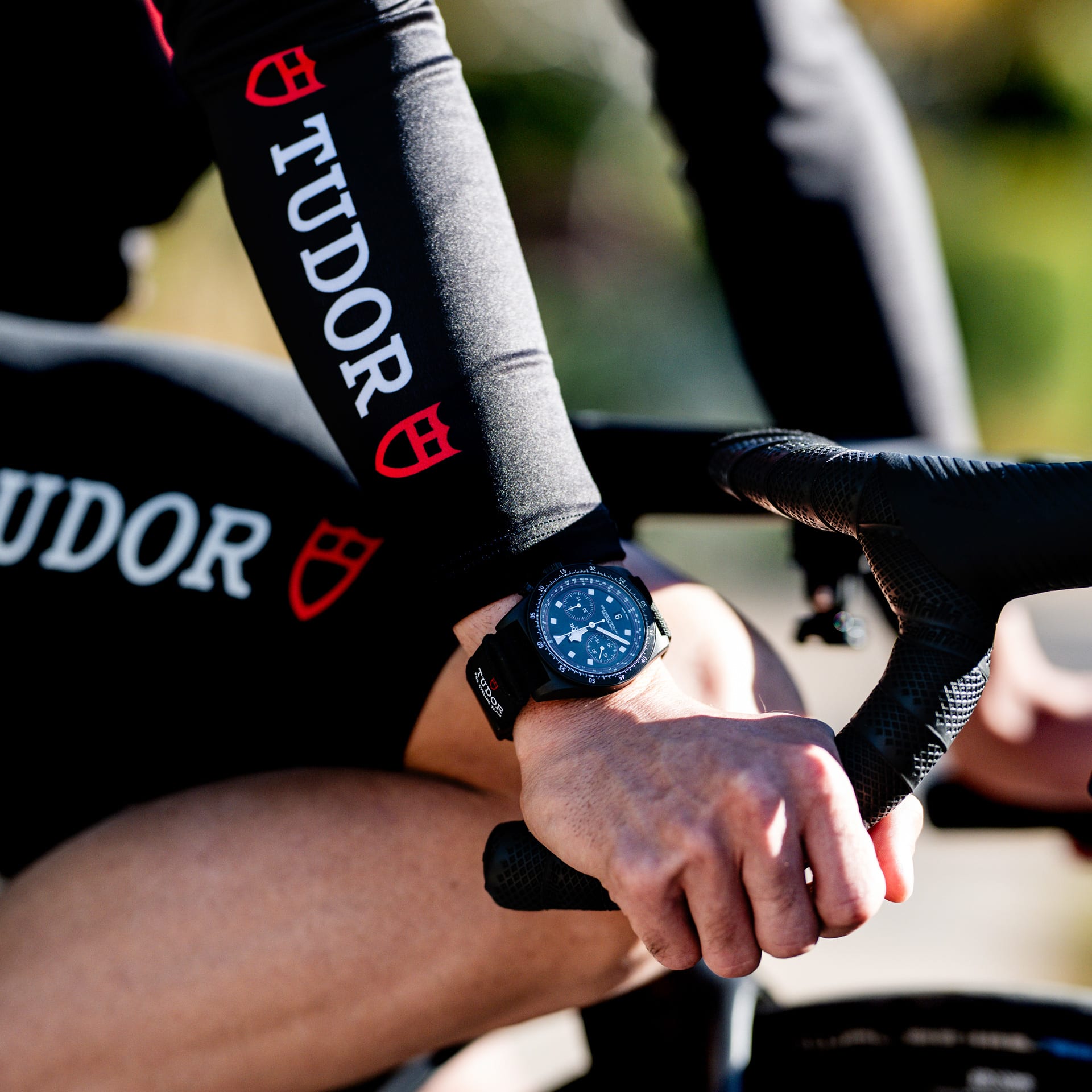 A Tudor watch on the cyclist’s wrist